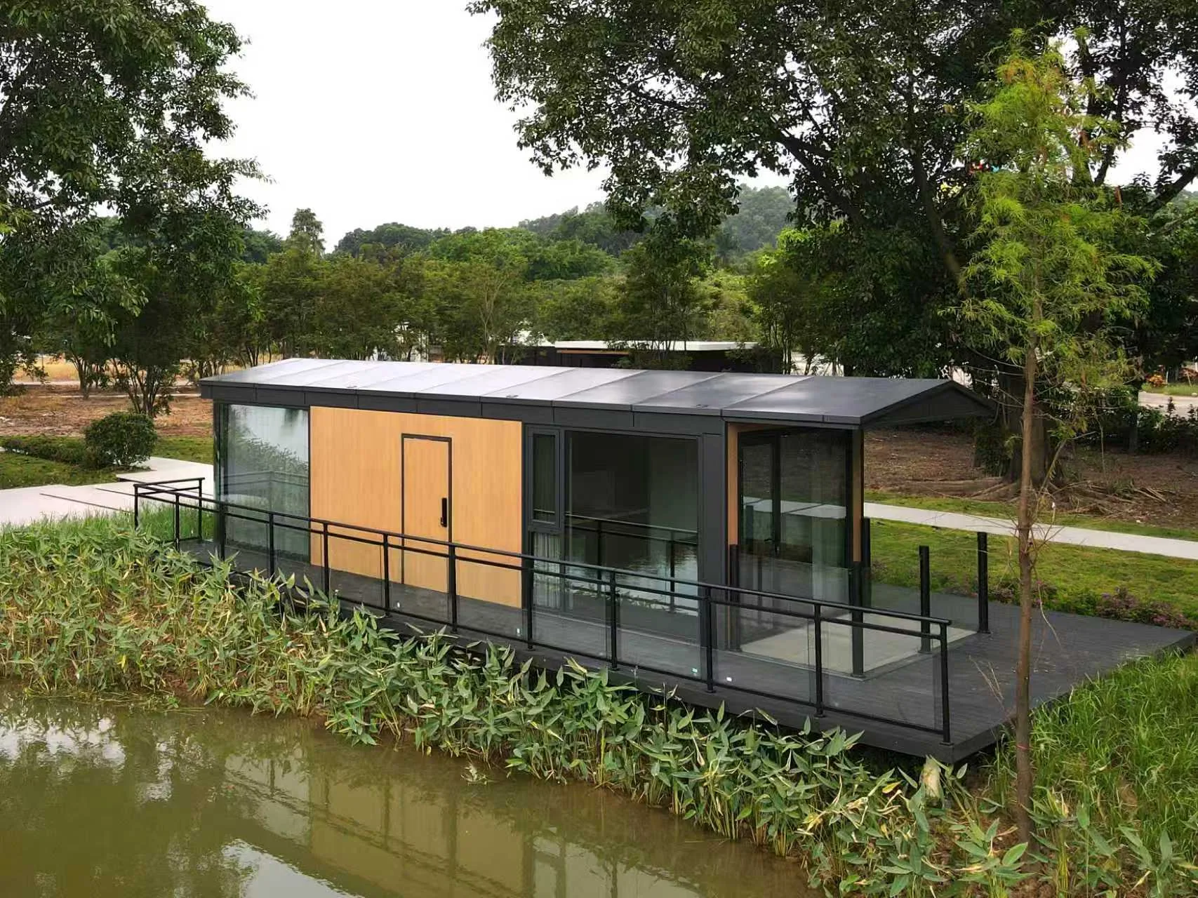 Custom modular building design concept beside a pond